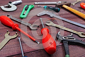 New and rusty of locksmith tools for repair work on wooden background