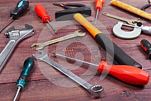 New and rusty of plumbing tools for house work on wooden background