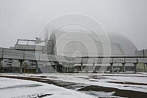 New Safe Confinement above remains of reactor 4 and old sarcophagus at Chernobyl nuclear power plant. Ukraine