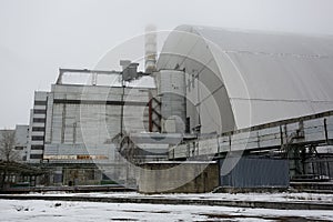 New Safe Confinement above remains of reactor 4 and old sarcophagus at Chernobyl nuclear power plant. Ukraine