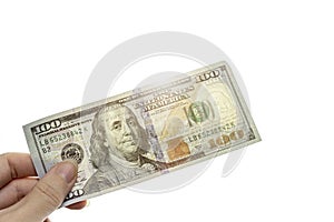 New sample money. Close up perspective view of hundred-dollar bill in human hand with sunlight
