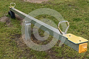 New seesaw on a children`s playground with lawn