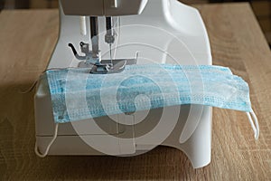 New sewing machine sews a medical mask close-up during a pandemic