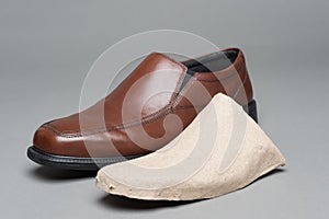 A new shoe and the cardboard insert used to preserve its shape