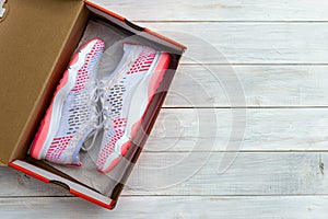 New shoes in boxed on wooden table background. photo