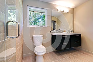 New simple modern bathroom with double sinks and natural ceramic tile.