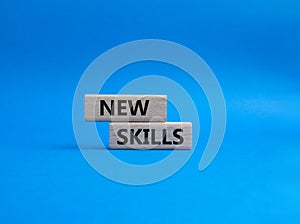 New skills symbol. Concept words new skills on wooden blocks. Beautiful blue background. Business and new skills concept. Copy