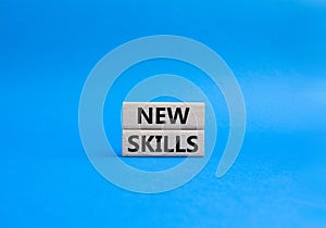 New skills symbol. Concept words new skills on wooden blocks. Beautiful blue background. Business and new skills concept. Copy