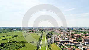 New Skyline of Milan seen from the Milanese hinterland, aerial view, tree lined avenue. Pedestrian cycle path