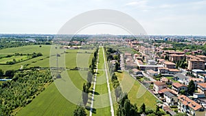 New Skyline of Milan seen from the Milanese hinterland, aerial view, tree lined avenue. Pedestrian cycle path