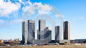 New skyscraper against the background of blue sky, beautiful new building residential complex, construction of residential