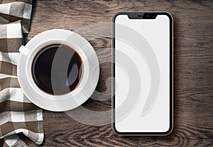 New smartphone similar to iphone X top view on old wood table with cloth and coffee