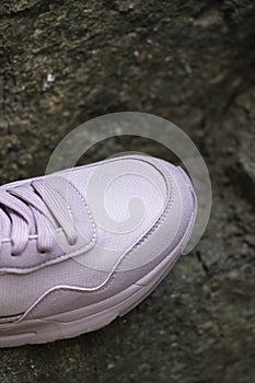 New sneaker on the background of stones