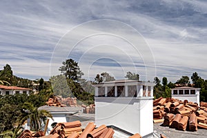 New Spanish style roof tiles loaded on a large roof