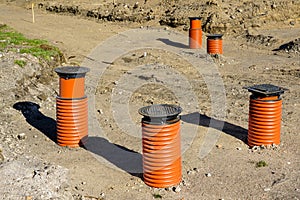 New gutter system for rainwater sewer, cast iron grating and brown plastic sewer pipes for drainage