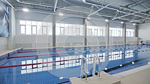 New swimming pool in brightly lit hall of sports complex