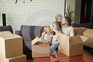 New tenants family with kids and boxes enjoying moving day