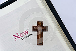 New testament cover in Holy Bible with a wooden cross