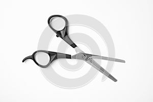 New thinning scissors on white, top view. Professional hairdresser tool