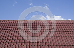 New tiled roof with louvered roof vent in the sky photo