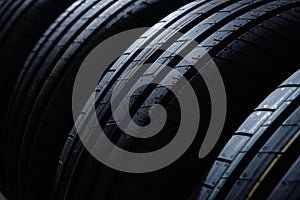 New tires background. Set of tyres on the dark background