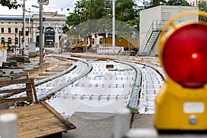 New tram rails laying on european city street. Installation modern railway tramway rails for trams. Reconstruction