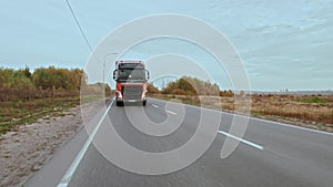 New truck is driving on suburban multi-lane road. Getting closer to the camera