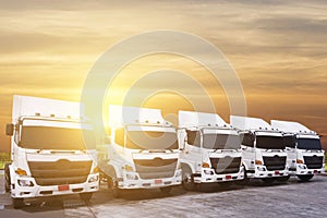 New truck fleet is parking at yard with beautiful sunset as for transportation
