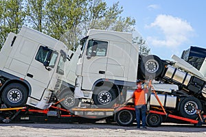New trucks on a carrier truck, that delivers them to customers