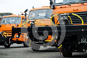 New Trucks standing in a row on an orange-colored street