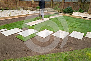 New turf installation within an area with new slab stepping stones, in a newly landscaped garden