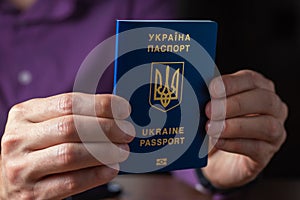 New ukrainian blue biometric passport with identification chip in hands