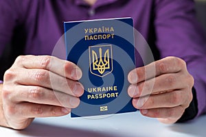 New ukrainian blue biometric passport with identification chip in hands