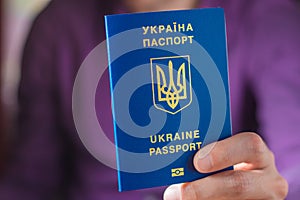 New ukrainian blue biometric passport with identification chip in hands
