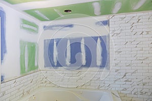 New under construction bathroom interior with drywall and patching