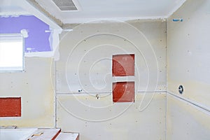 New under construction bathroom interior with drywall and patching