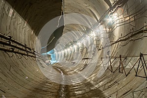 New, under construction, empty concrete round deep subway tunnel made of concrete blocks
