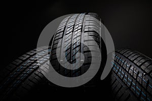 New and unused car tires against dark background