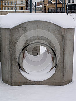 New unused concrete pipe covered in snow