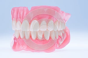 New upper and lower dentures on a light background.