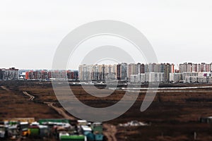 New urban areas, buildings, construction site of a residential complex in a field on the outskirts of the city on a cloudy day