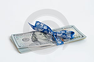 New US one hundred dollar banknote tied with blue christmas ribbon