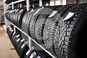 new and used automobile tires on the store rack