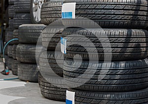 New and used car tyres shown at a tyre shop.