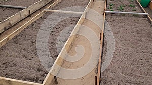 new vegetable garden built with raised wooden beds with fertile soil to cultivate.