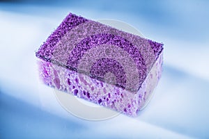 New violet sponge on white background
