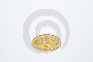 New virtual money: Golden bitcoin coin on a white Background. The future Cryptocurrency. Business and Trading concept.