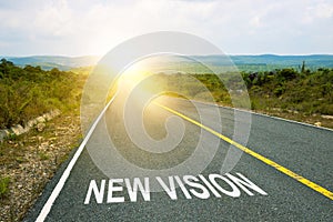 New Vision inscription on straight road. Motivational inscription on the road going forward. The beginning of a new path. A