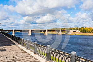 The new Volga bridge and city quay in Tver, Russia. Picturesque river landscape. Clouds in the blue sky