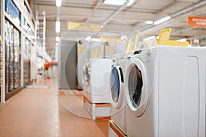 New washing machines in electronics store, nobody